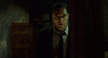 Movie still from “The Shape of Water” (2017), directed by Guillermo del Toro – A person wearing a suit and tie; Medium shot, Low angle