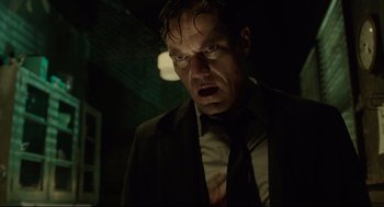 Movie still from “The Shape of Water” (2017), directed by Guillermo del Toro – A person wearing a suit and tie; Close Up shot, Low angle