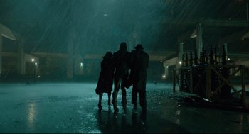 Movie still from “The Shape of Water” (2017), directed by Guillermo del Toro – A group of people standing in the middle of the rain; Wide shot, Low angle