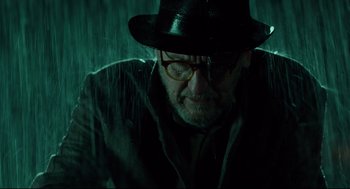 Movie still from “The Shape of Water” (2017), directed by Guillermo del Toro – An older man wearing a hat and glasses in the rain; Close Up shot, Low angle