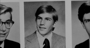 Movie still from “Field of Dreams” (1989), directed by Phil Alden Robinson – An old black and white photo of a man in a suit and tie; Extreme Close Up shot, Overhead angle