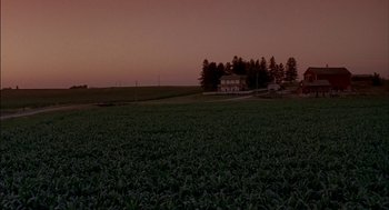 Movie still from “Field of Dreams” (1989), directed by Phil Alden Robinson – A large field with a house in the background; Extreme Wide shot, High angle