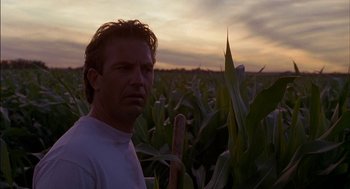 Movie still from “Field of Dreams” (1989), directed by Phil Alden Robinson – A man standing in a corn field at sunset; Close Up shot, Low angle
