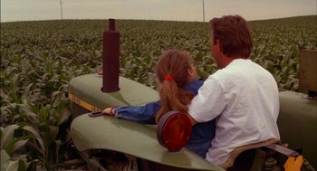 Movie still from “Field of Dreams” (1989), directed by Phil Alden Robinson – A man and a little girl sitting on a tractor; Medium shot, Over the shoulder angle