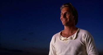 Movie still from “Field of Dreams” (1989), directed by Phil Alden Robinson – A man in a white shirt is smiling at the sky; Close Up shot, Low angle