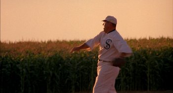 Movie still from “Field of Dreams” (1989), directed by Phil Alden Robinson – A baseball player throwing a ball in a field of corn; Medium shot, Over the shoulder angle