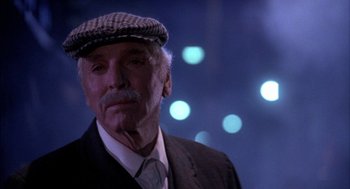 Movie still from “Field of Dreams” (1989), directed by Phil Alden Robinson – An older man wearing a hat and a suit; Close Up shot, Low angle