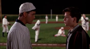 Movie still from “Field of Dreams” (1989), directed by Phil Alden Robinson – Two baseball players talking to each other on a field; Medium shot, Over the shoulder angle