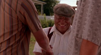 Movie still from “Field of Dreams” (1989), directed by Phil Alden Robinson – An older man holding hands with a younger man; Medium shot, Low angle