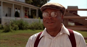 Movie still from “Field of Dreams” (1989), directed by Phil Alden Robinson – An older man wearing glasses and a hat; Close Up shot, Low angle