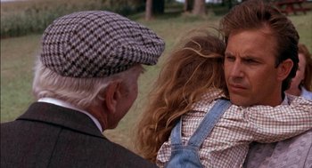 Movie still from “Field of Dreams” (1989), directed by Phil Alden Robinson – An old man and a young girl in a field; Close Up shot, Over the shoulder angle