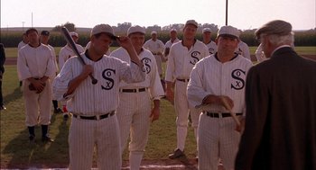 Movie still from “Field of Dreams” (1989), directed by Phil Alden Robinson – A group of baseball players standing on top of a baseball field; Medium shot, Over the shoulder angle