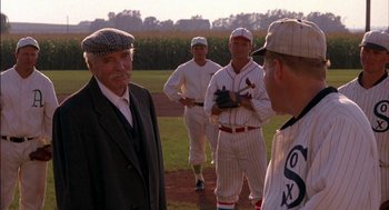 Movie still from “Field of Dreams” (1989), directed by Phil Alden Robinson – A group of baseball players standing on top of a baseball field; Medium shot, Over the shoulder angle