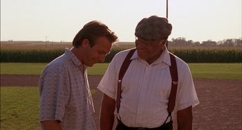 Movie still from “Field of Dreams” (1989), directed by Phil Alden Robinson – Two men standing next to each other on a field; Medium shot, Over the shoulder angle