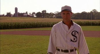 Movie still from “Field of Dreams” (1989), directed by Phil Alden Robinson – A man in a baseball uniform standing on a field; Medium shot, Over the shoulder angle