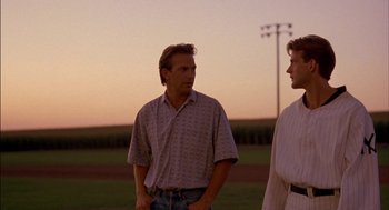 Movie still from “Field of Dreams” (1989), directed by Phil Alden Robinson – Two men standing in a field at sunset; Medium shot, Over the shoulder angle