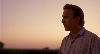 Movie still from “Field of Dreams” (1989), directed by Phil Alden Robinson – A person looking at the sky; Close Up shot, Over the shoulder angle