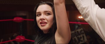 Movie still from “Fighting with My Family” (2019), directed by Stephen Merchant – A person with long black hair; Close Up shot, Low angle