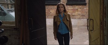 Movie still from “Fighting with My Family” (2019), directed by Stephen Merchant – A woman in a blue shirt and a brown jacket; Medium shot, Over the shoulder angle