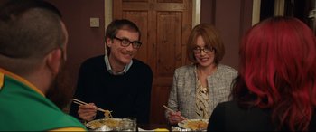 Movie still from “Fighting with My Family” (2019), directed by Stephen Merchant – A man and a woman sitting at a dinner table; Medium shot, Over the shoulder angle