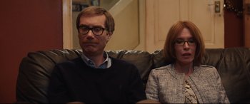 Movie still from “Fighting with My Family” (2019), directed by Stephen Merchant – A man and a woman sitting on a couch; Medium shot, Over the shoulder angle