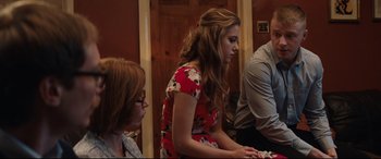 Movie still from “Fighting with My Family” (2019), directed by Stephen Merchant – A woman in a red floral dress sitting next to a woman in glasses; Medium shot, Over the shoulder angle