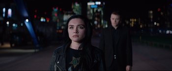 Movie still from “Fighting with My Family” (2019), directed by Stephen Merchant – A woman in a black jacket standing next to a man in a black jacket; Medium shot, Over the shoulder angle