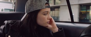 Movie still from “Fighting with My Family” (2019), directed by Stephen Merchant – A woman sitting in a car with her head resting on her hand; Close Up shot, Over the shoulder angle