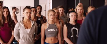 Movie still from “Fighting with My Family” (2019), directed by Stephen Merchant – A group of young people standing together in a room; Medium shot, Over the shoulder angle