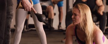 Movie still from “Fighting with My Family” (2019), directed by Stephen Merchant – A woman in a pink top is looking at an exercise ball; Close Up shot, Over the shoulder angle