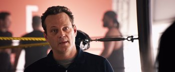 Movie still from “Fighting with My Family” (2019), directed by Stephen Merchant – A person in a room with a camera; Close Up shot, Over the shoulder angle