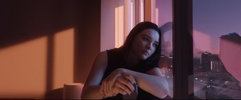 Movie still from “Fighting with My Family” (2019), directed by Stephen Merchant – A woman sitting in front of a window in a dark room; Close Up shot, Low angle