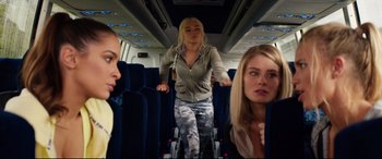 Movie still from “Fighting with My Family” (2019), directed by Stephen Merchant – A woman riding a bike down the middle of a train; Medium shot, Low angle