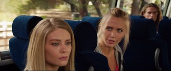 Movie still from “Fighting with My Family” (2019), directed by Stephen Merchant – Two young women sitting on a seat on a bus; Close Up shot, Over the shoulder angle
