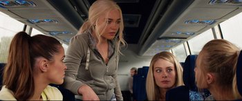 Movie still from “Fighting with My Family” (2019), directed by Stephen Merchant – Two women are sitting on a plane and one of the women is looking at the camera; Medium shot, Over the shoulder angle
