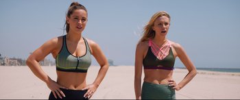 Movie still from “Fighting with My Family” (2019), directed by Stephen Merchant – Two young women standing on the beach wearing sports bras; Medium shot, Low angle