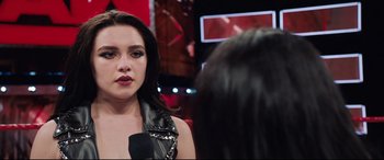 Movie still from “Fighting with My Family” (2019), directed by Stephen Merchant – A woman in a leather jacket looking into a mirror; Close Up shot, Over the shoulder angle