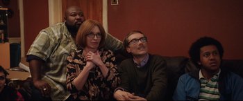 Movie still from “Fighting with My Family” (2019), directed by Stephen Merchant – A man and a woman sitting next to each other on a couch; Medium shot, Low angle