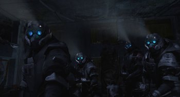 Movie still from “Final Fantasy: The Spirits Within” (2001), directed by Hironobu Sakaguchi – A group of people in a dark room with blue lights; Medium shot, Low angle