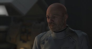 Movie still from “Final Fantasy: The Spirits Within” (2001), directed by Hironobu Sakaguchi – A man with a bald head wearing a uniform; Close Up shot, Over the shoulder angle