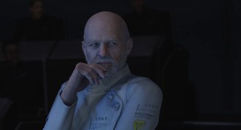 Movie still from “Final Fantasy: The Spirits Within” (2001), directed by Hironobu Sakaguchi – An older man with a bald head is sitting in front of a computer screen; Close Up shot, Over the shoulder angle