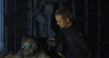 Movie still from “Final Fantasy: The Spirits Within” (2001), directed by Hironobu Sakaguchi – A man in a black shirt is petting a robot; Close Up shot, Over the shoulder angle