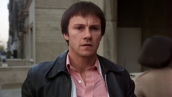 Movie still from “Fingers” (1978), directed by James Toback – A person wearing a pink shirt; Close Up shot, Low angle