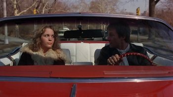 Movie still from “Fingers” (1978), directed by James Toback – A man and a woman sitting in the back of a red car; Medium shot, Low angle