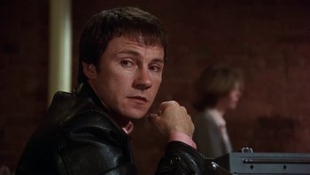 Movie still from “Fingers” (1978), directed by James Toback – A person wearing a leather jacket; Close Up shot, Low angle