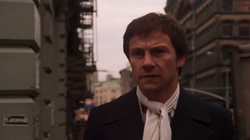 Movie still from “Fingers” (1978), directed by James Toback – A person wearing a suit and tie; Close Up shot, Low angle