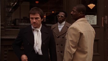 Movie still from “Fingers” (1978), directed by James Toback – A group of men standing next to each other on the street; Medium shot, Low angle