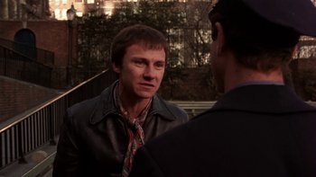 Movie still from “Fingers” (1978), directed by James Toback – A man wearing a leather jacket talking to another man; Close Up shot, Over the shoulder angle
