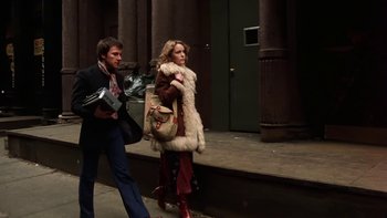Movie still from “Fingers” (1978), directed by James Toback – A man and a woman walking down a street; Wide shot, Low angle