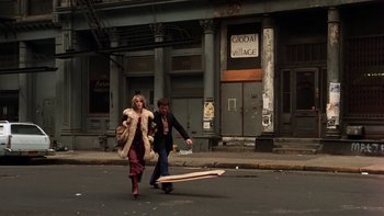 Movie still from “Fingers” (1978), directed by James Toback – A man and a woman walking down a street; Wide shot, High angle